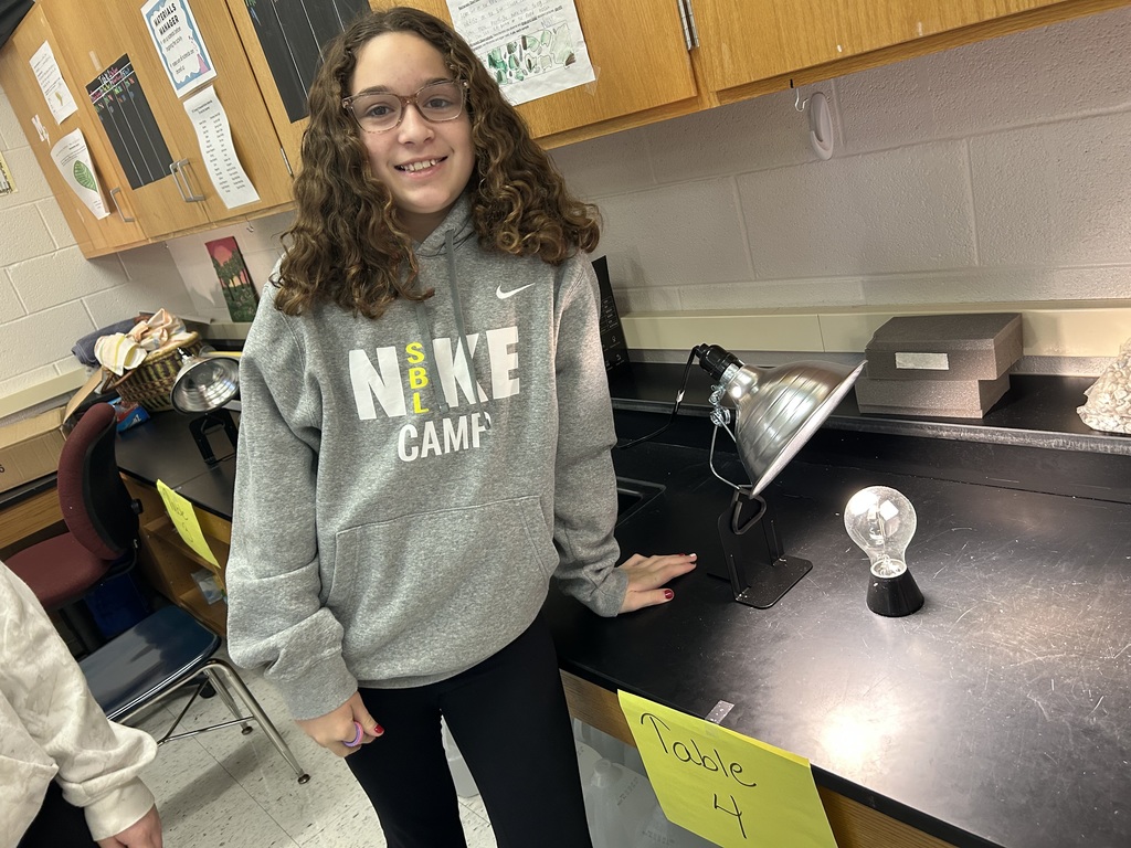 6th graders investigating direct and indirect sunlight with lamp