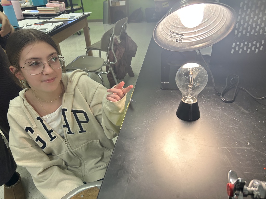 6th graders investigating direct and indirect sunlight with lamp