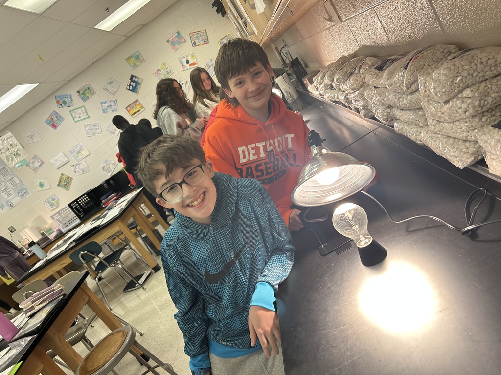 6th graders investigating direct and indirect sunlight with lamp