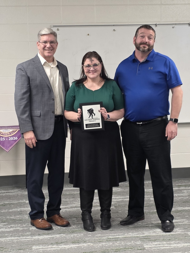 MIS principal and teacher with wounded wariors plaque
