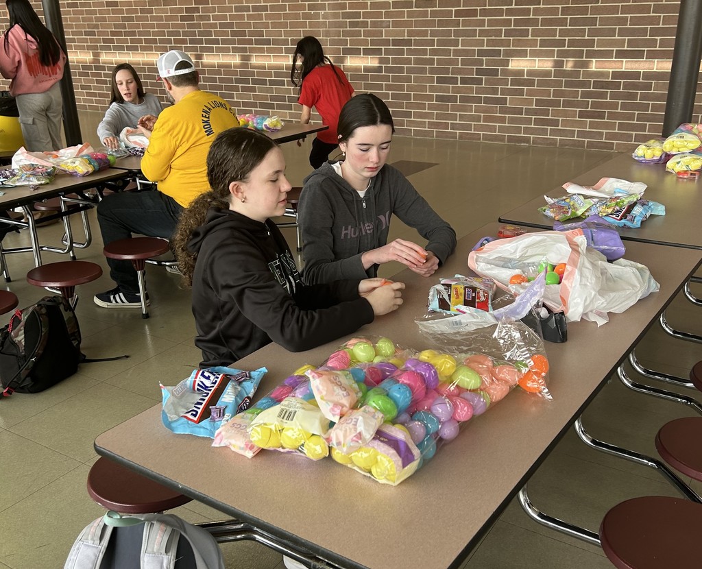volunteers putting candy in easter eggs
