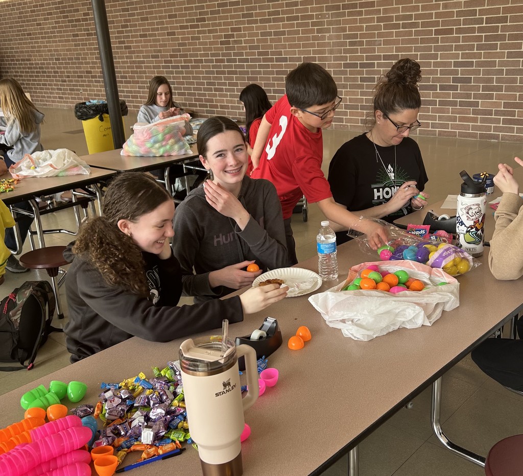 volunteers putting candy in easter eggs