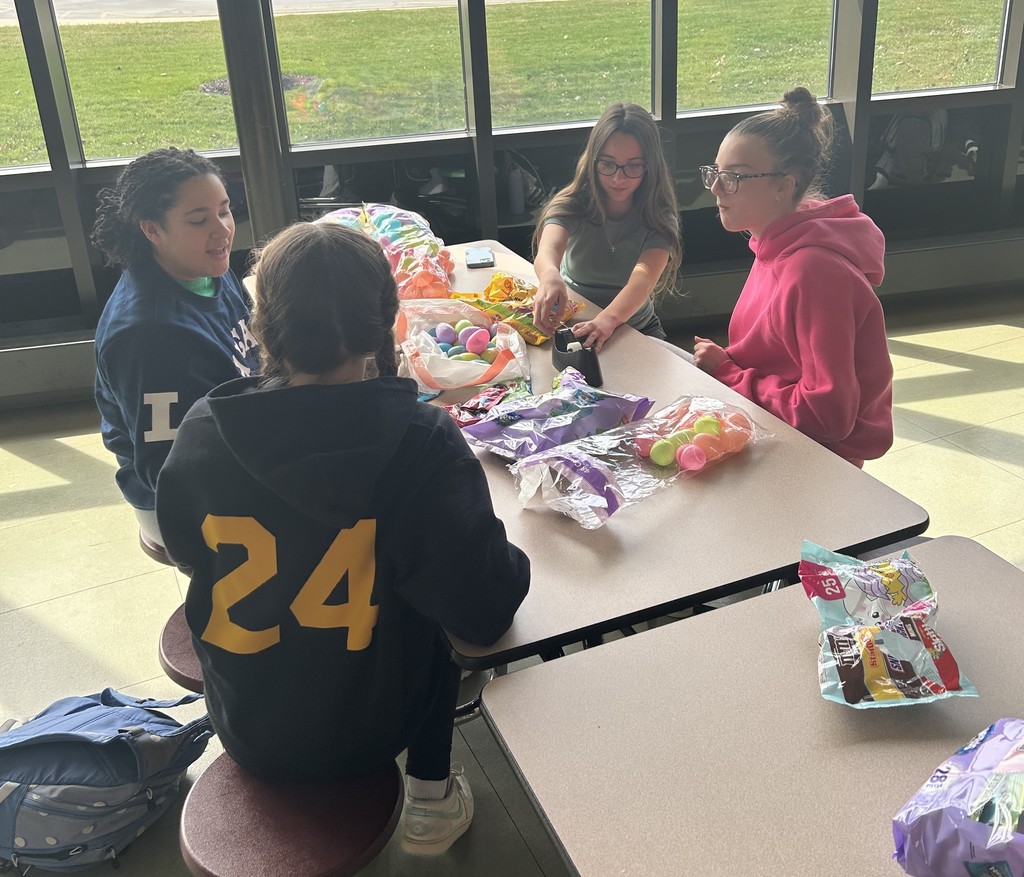 volunteers putting candy in easter eggs
