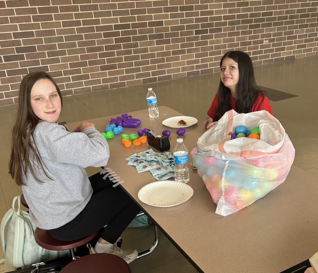 volunteers putting candy in easter eggs
