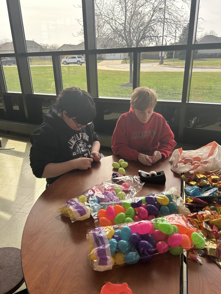 volunteers putting candy in easter eggs