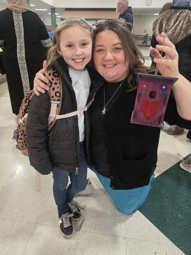 first graders making a birdhouse with an adult
