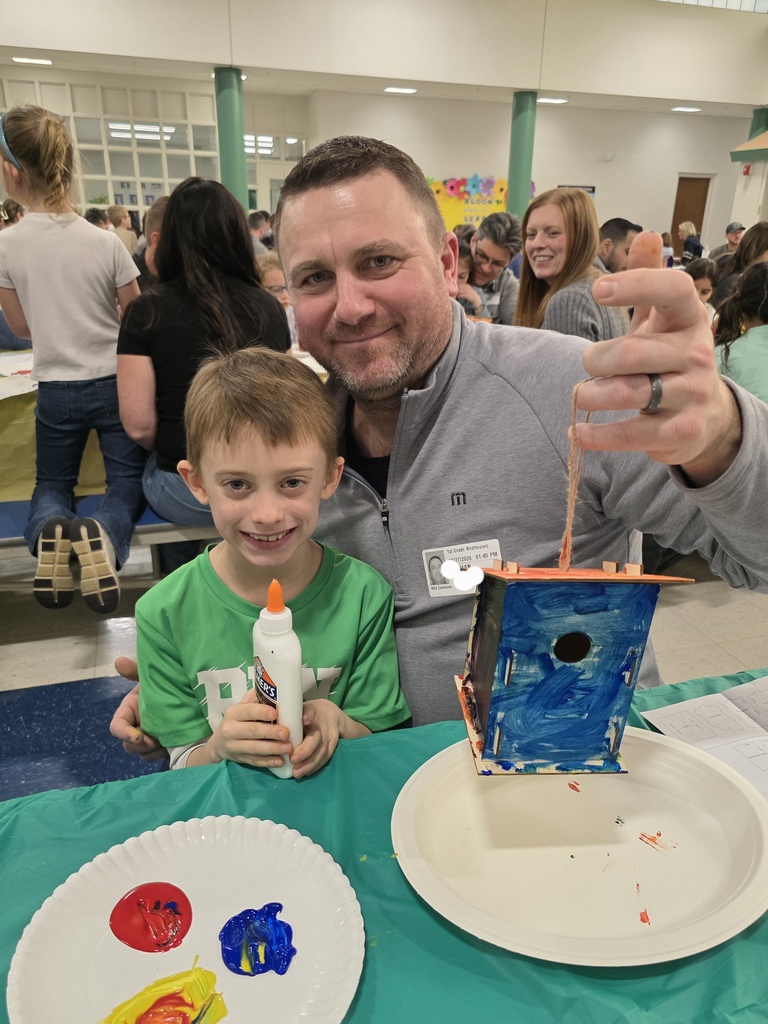 first graders making a birdhouse with an adult