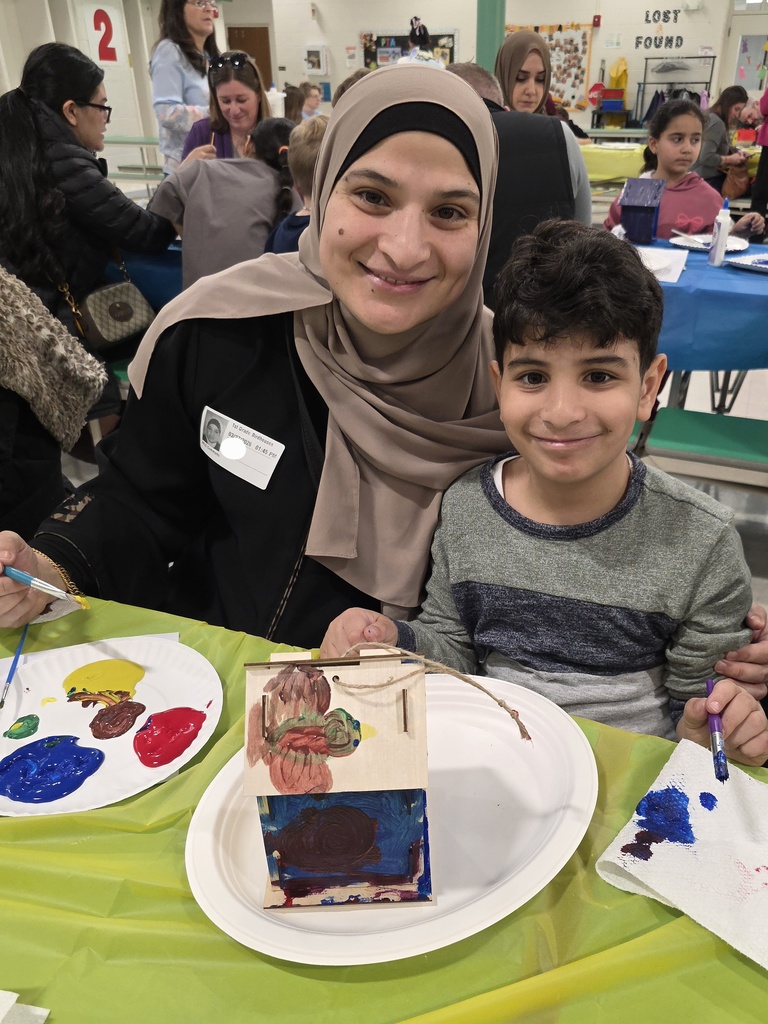 first graders making a birdhouse with an adult