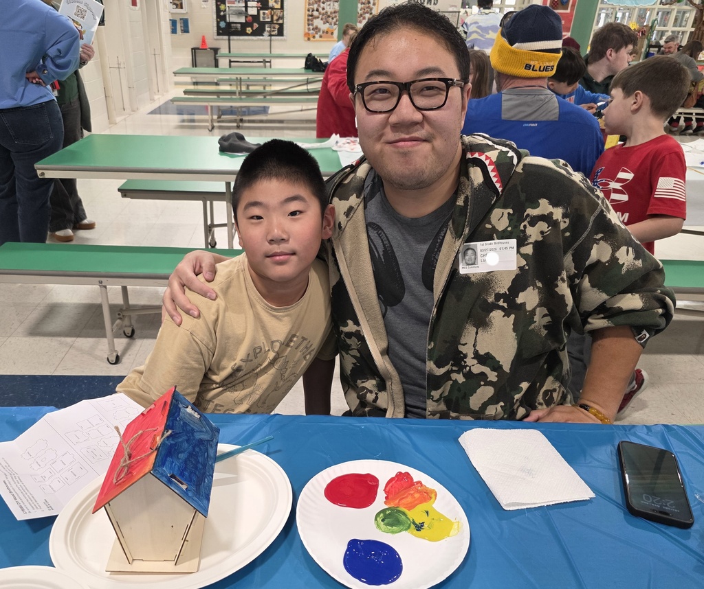 first graders making a birdhouse with an adult