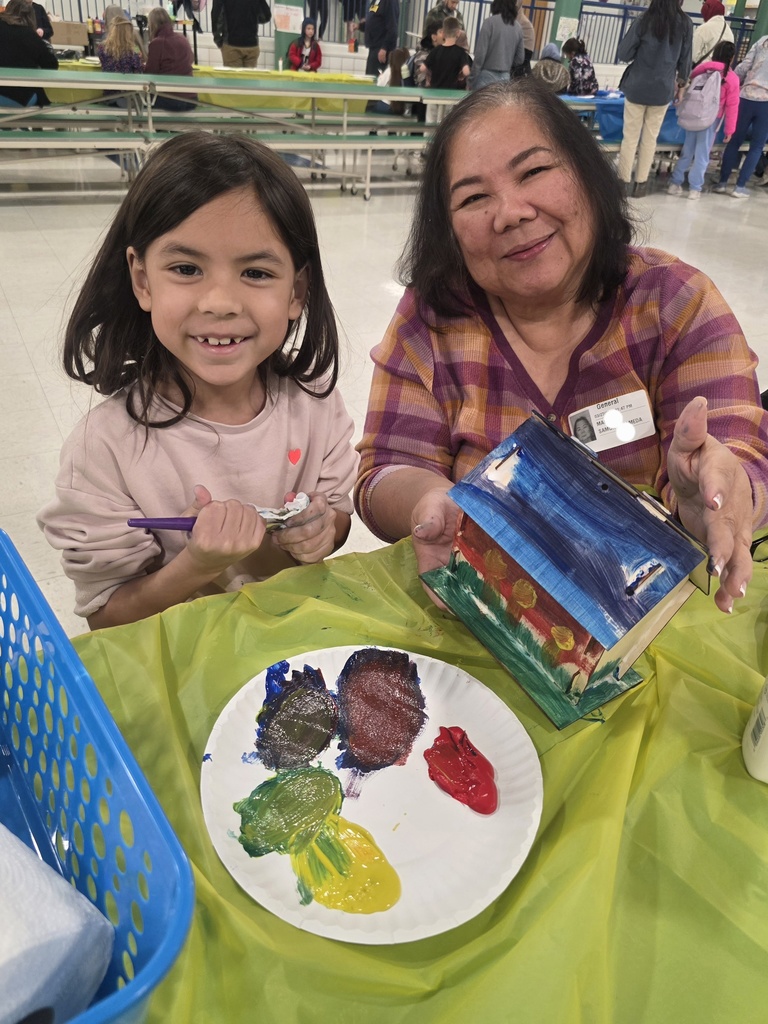 first graders making a birdhouse with an adult