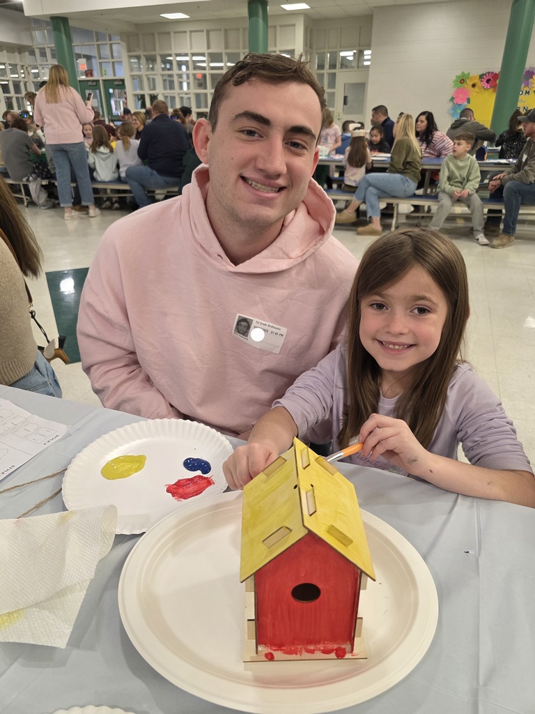 first graders making a birdhouse with an adult
