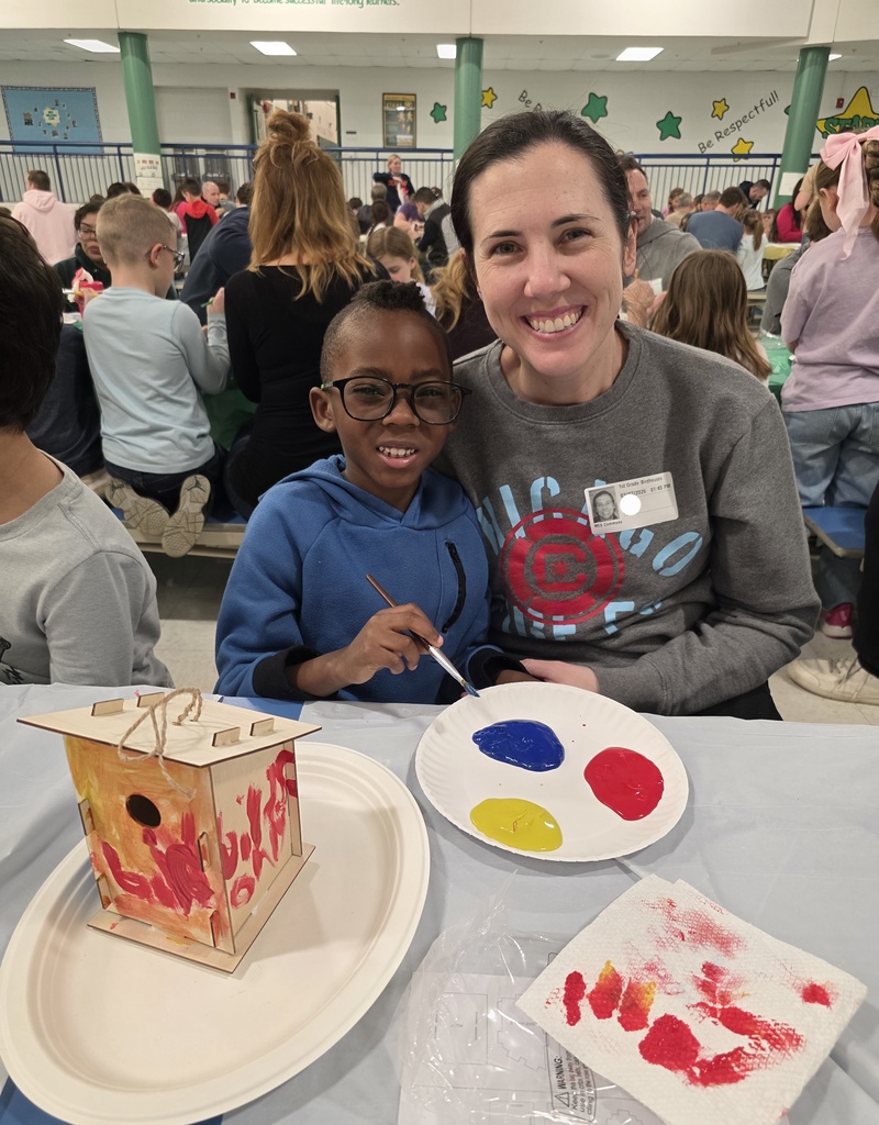 first graders making a birdhouse with an adult
