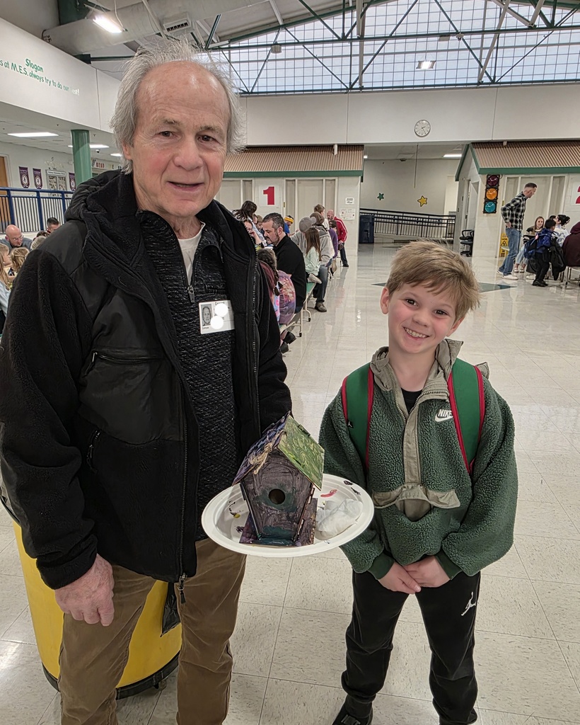 first graders making a birdhouse with an adult