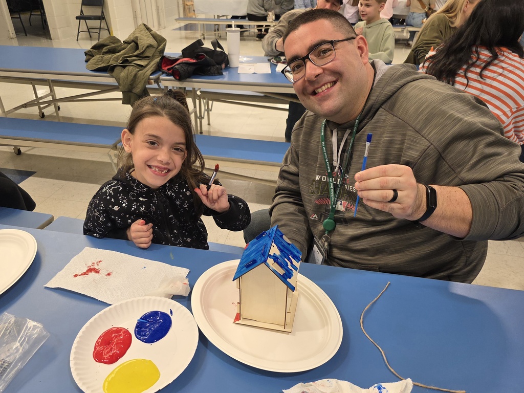 first graders making a birdhouse with an adult