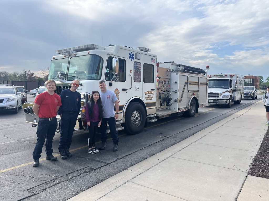sophie riding a fire truck to school