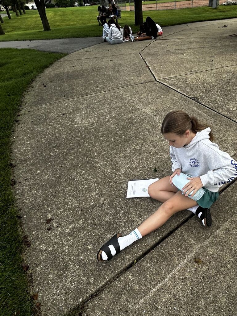 students creating scientific drawings outside