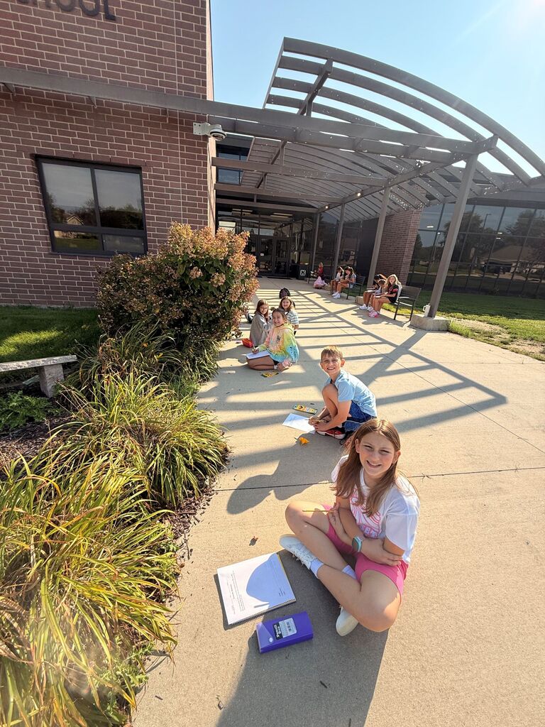 students creating scientific drawings outside