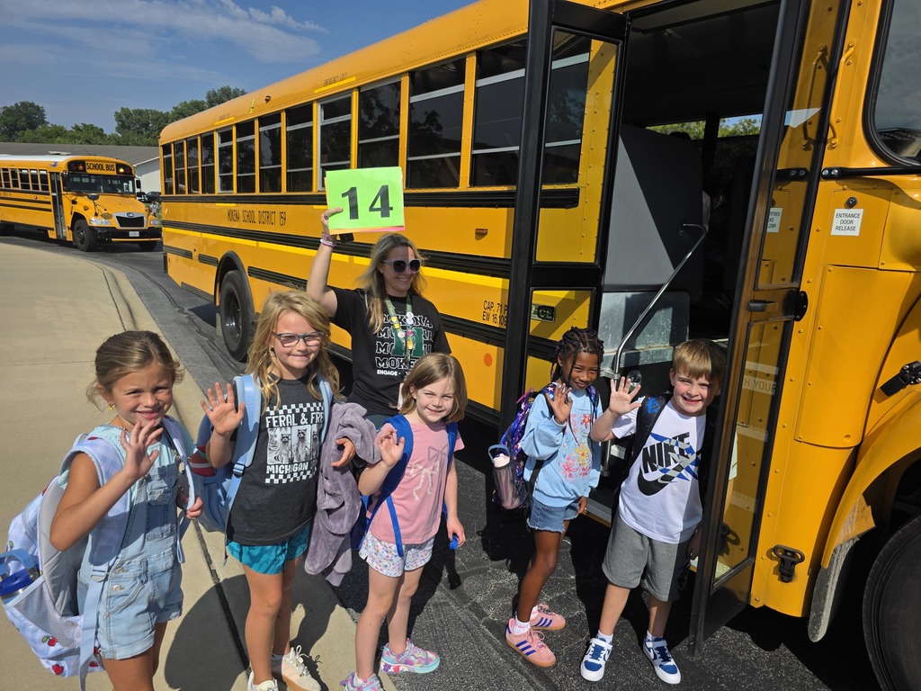 students waving by before getting on the bus