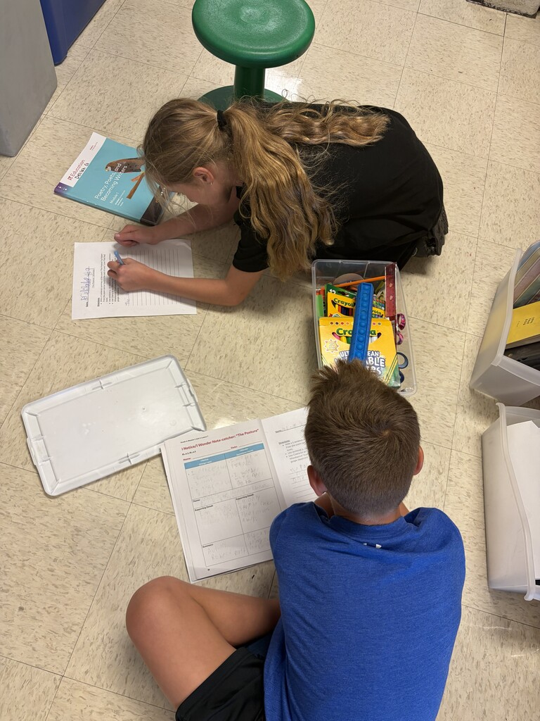 students working on writing summaries together