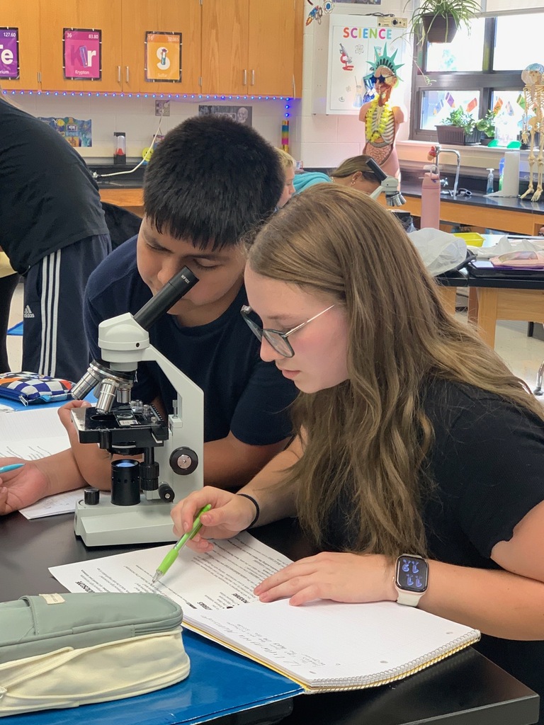 students looking into a microscope