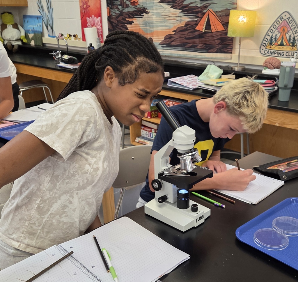 students looking into a microscope