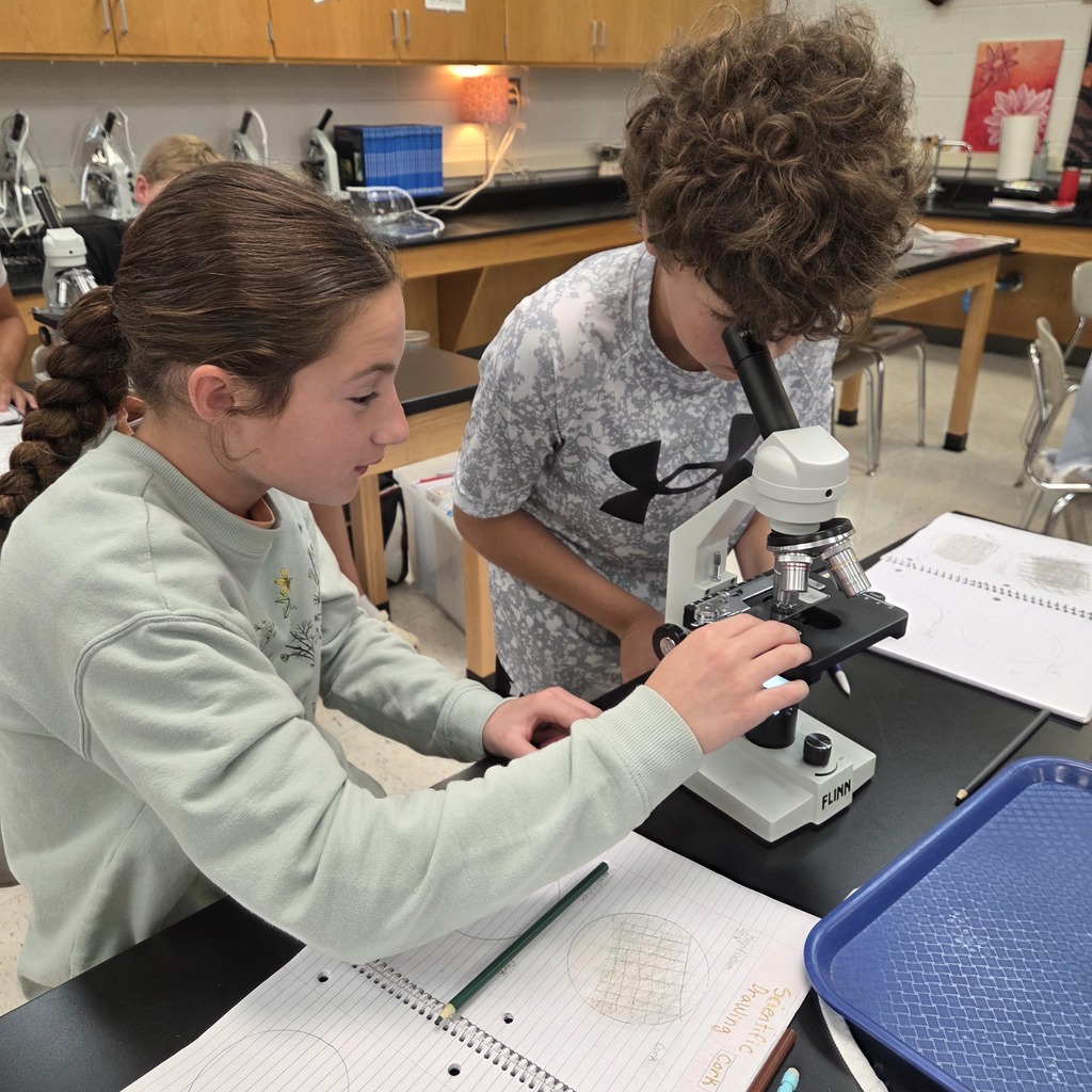students looking into a microscope