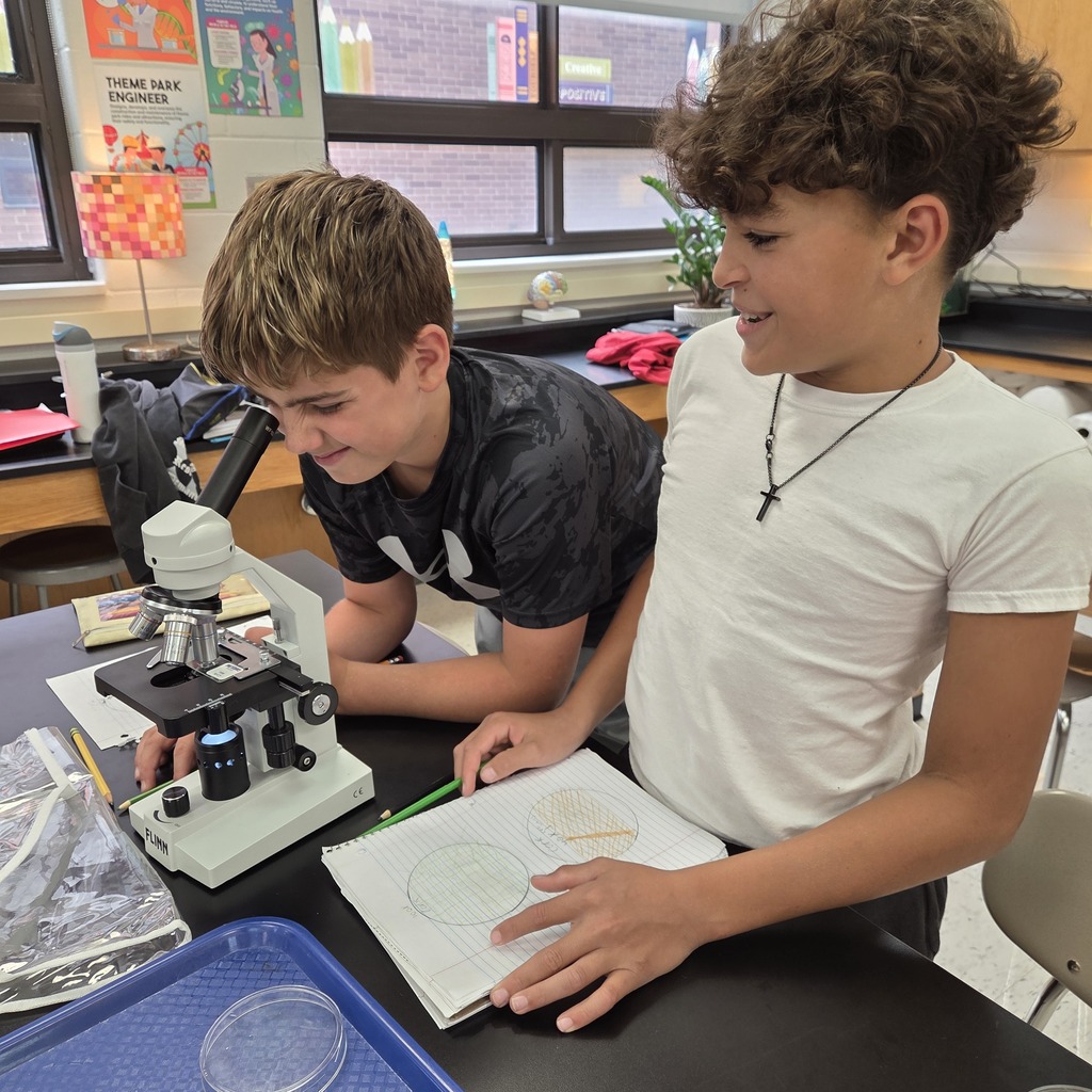 students looking into a microscope