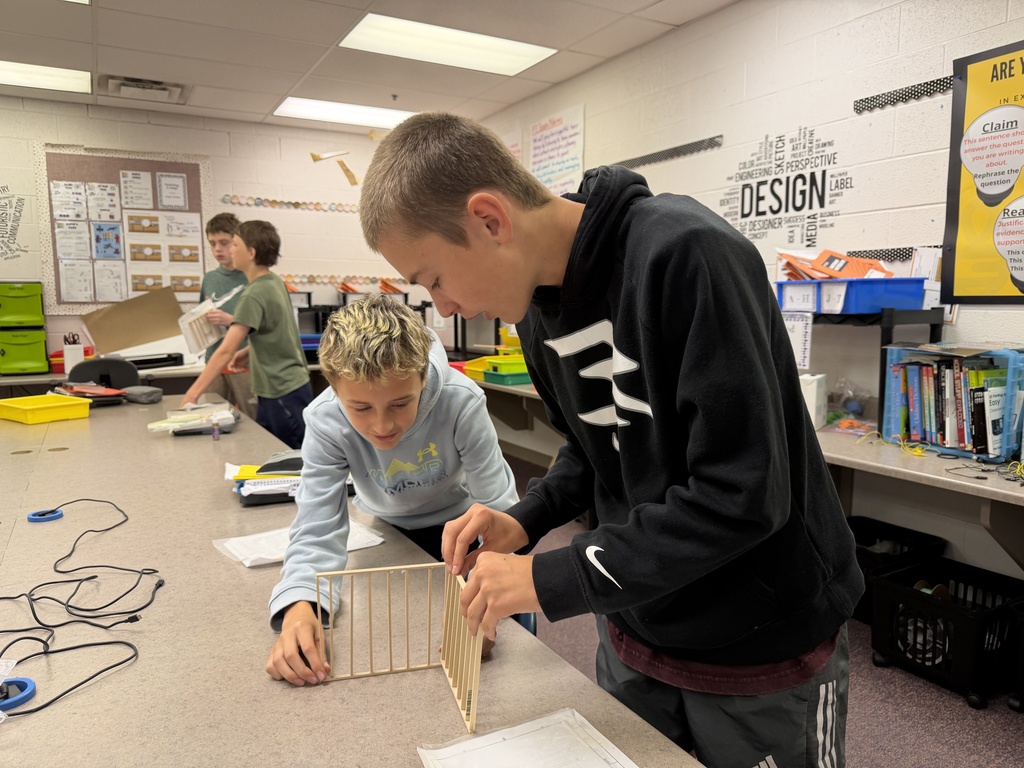 students building and designing a model house