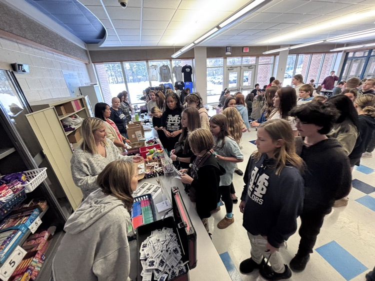 students in line and making purchases at the store