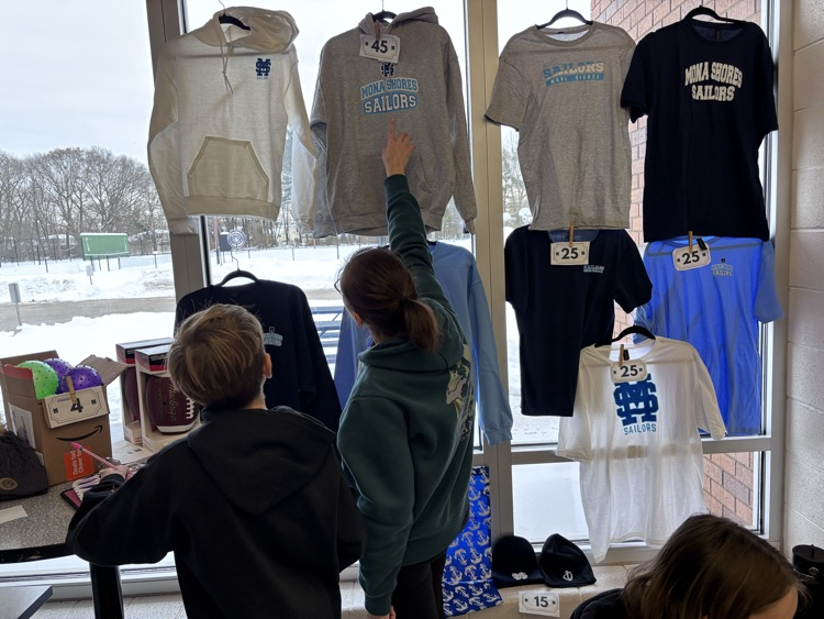 students checking out some apparel at the school store