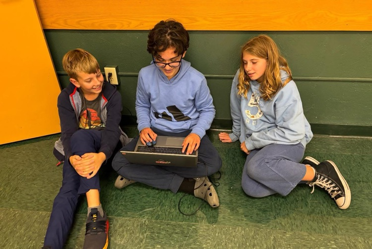 teammates working on a Chromebook 