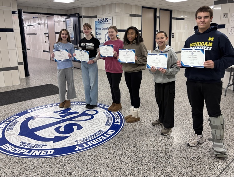 6 students standing in the foyer holding certificates 