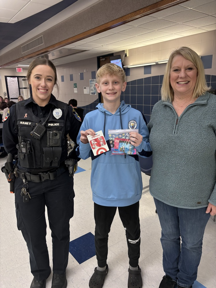 officer, student, and donor, celebrating gift card win