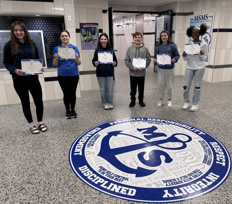 students in the foyer of MSMS showing certificates and smiles