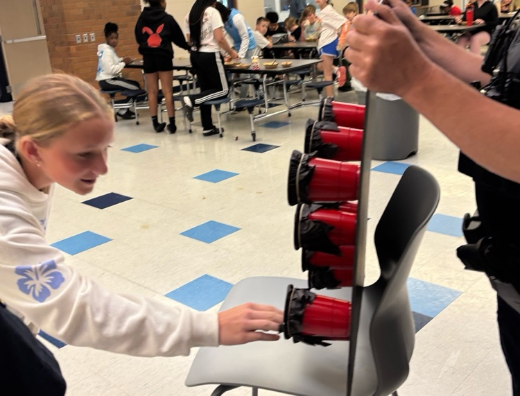 student selecting a cup for the ride with Pride game