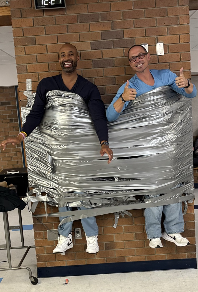 Mr Burrel and Mr Ammeraal duct taped to the wall of MSMS