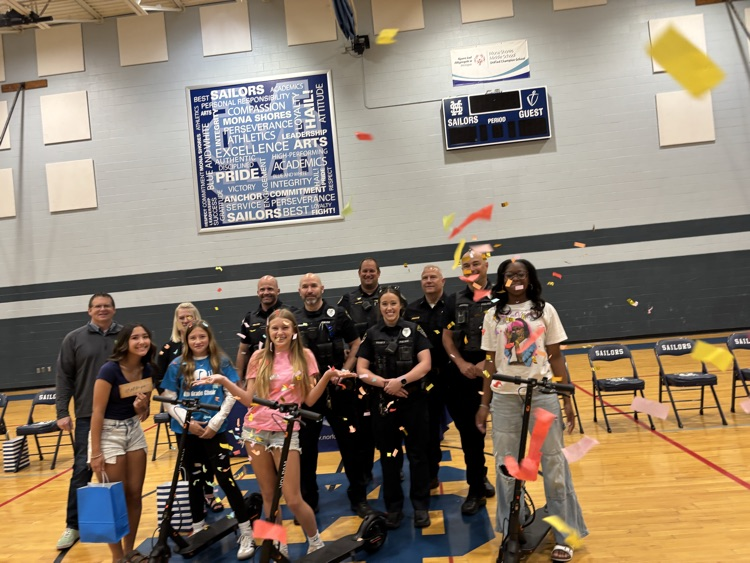 winners, donors, NSPD officers, and prizes with confetti flying