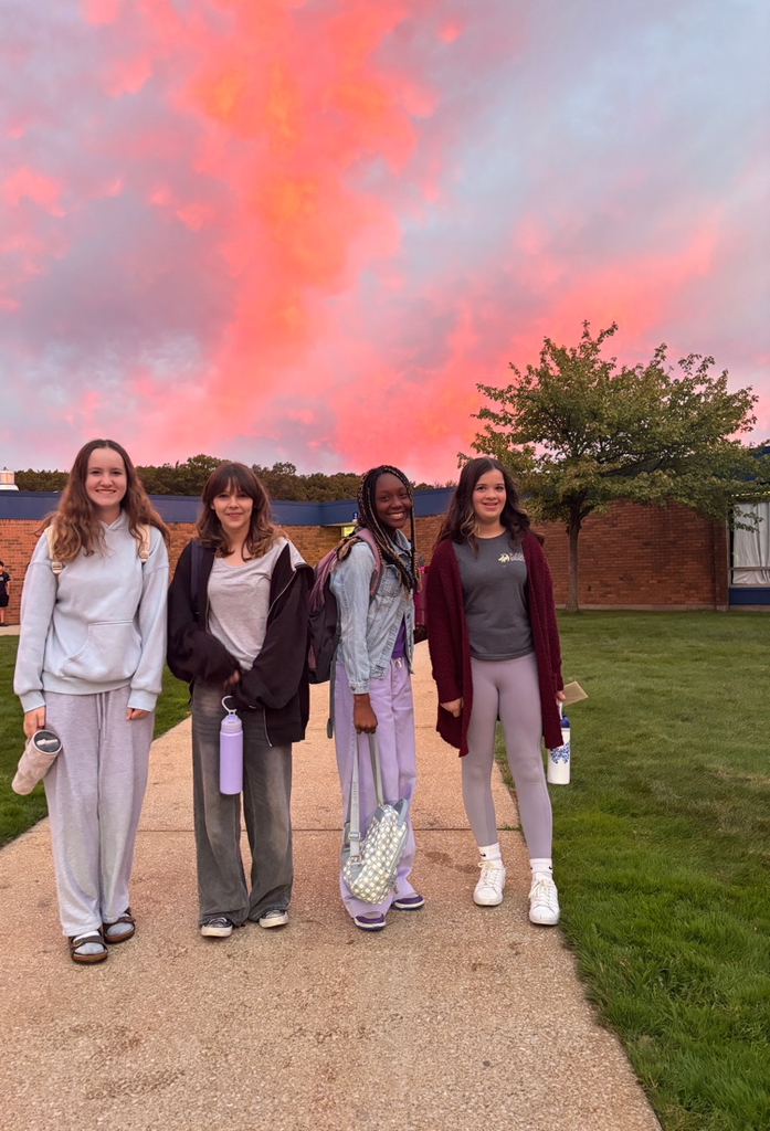 4 middle schoolers with beautiful sunrise in the background
