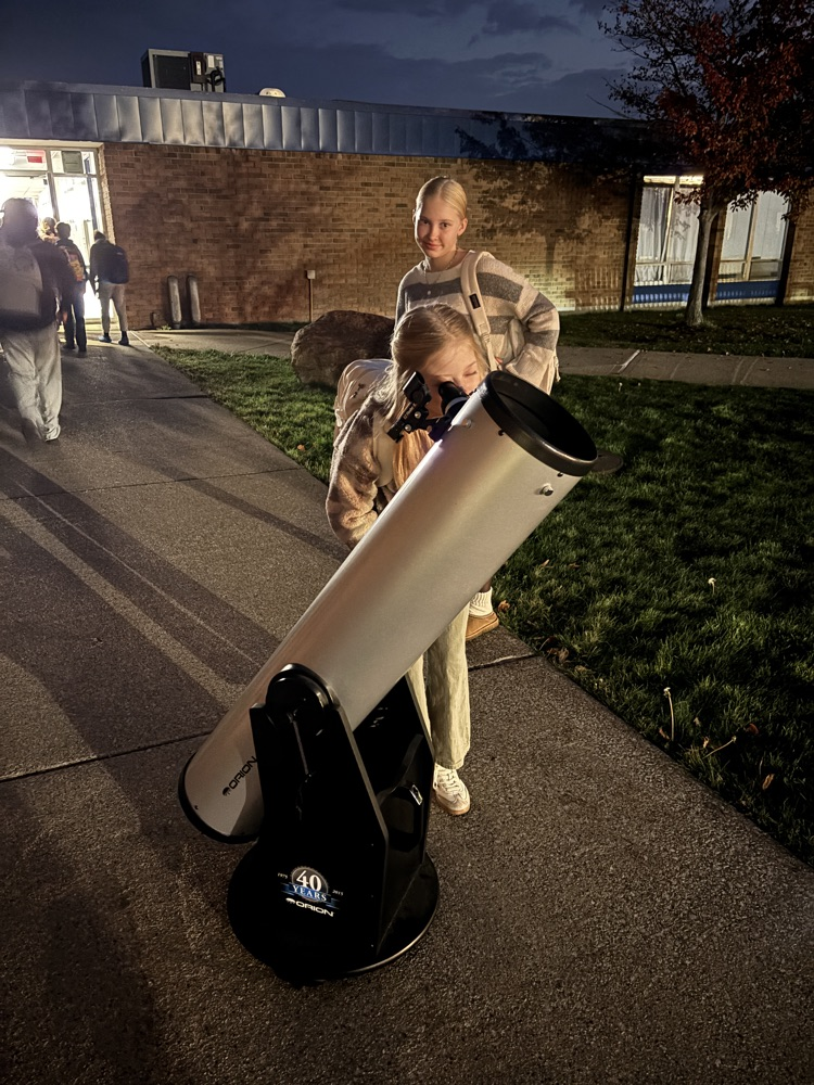 students looking through telescope