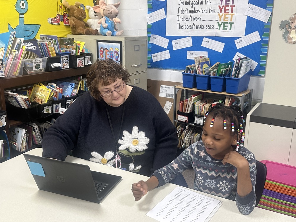 teacher and student using Chromebook