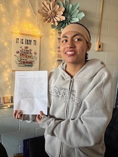 student showing off work