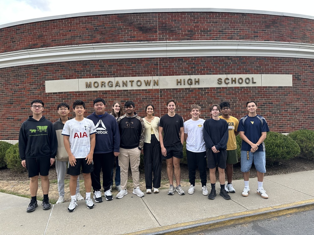 Students standing in front of a school