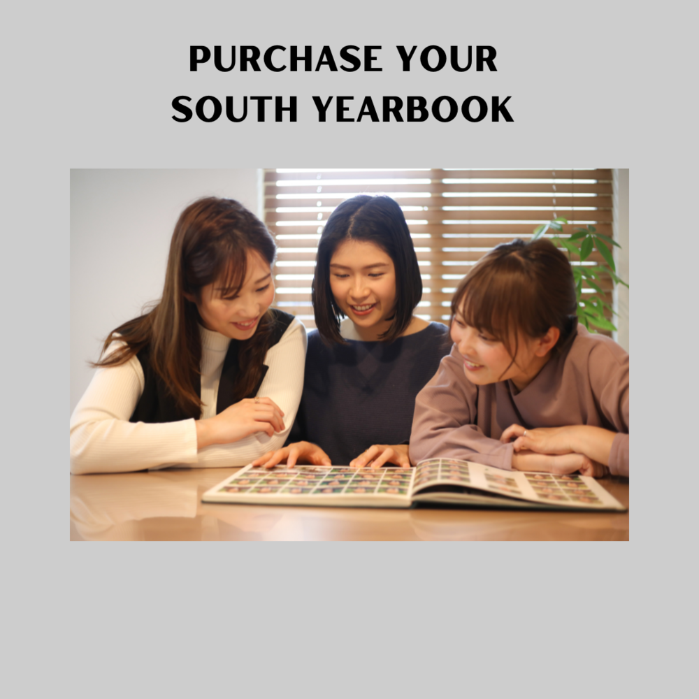 3 Girls looking at a yearbook