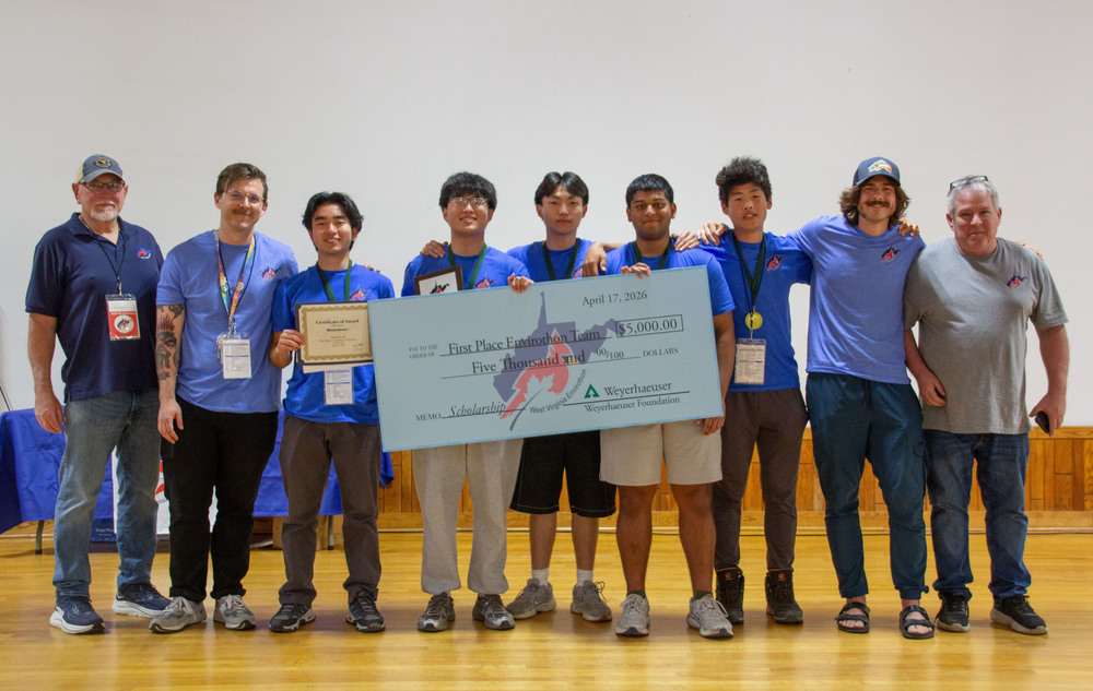 Peoples standing with a check 