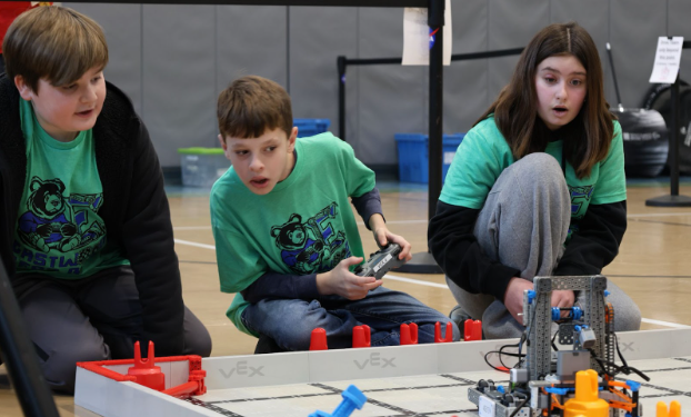 pic: Students driving a robot in a VexIQ challenge