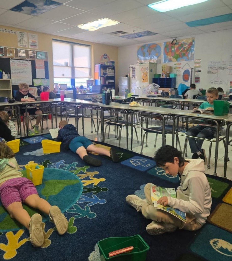 Group of students sitting on floor silent reading