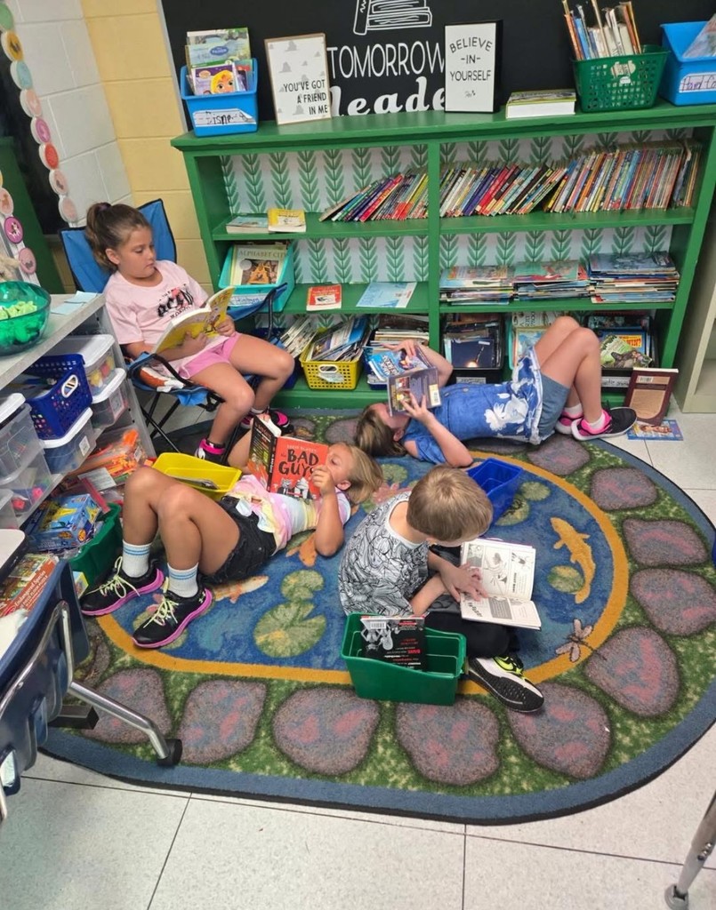 Students lounging in a reading nook silent reading