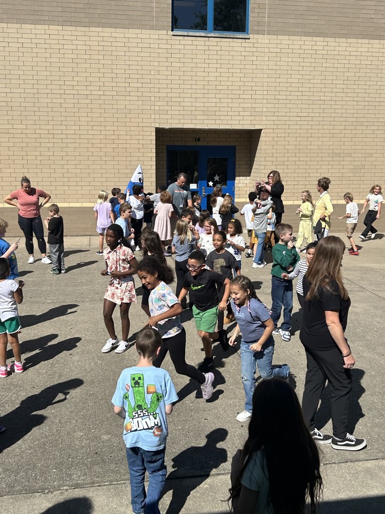 Students enjoying an outside dance party and bubble blowing to celebrate perfect attendance