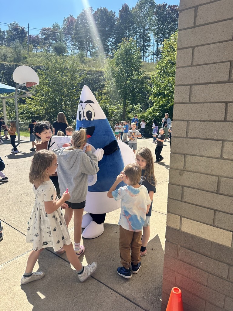 Students enjoying an outside dance party and bubble blowing to celebrate perfect attendance