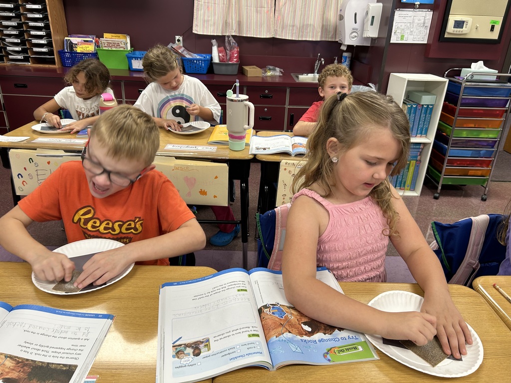 How does the land change? The students modeled "weathering" by rubbing rocks with sandpaper to show how land changes over time.